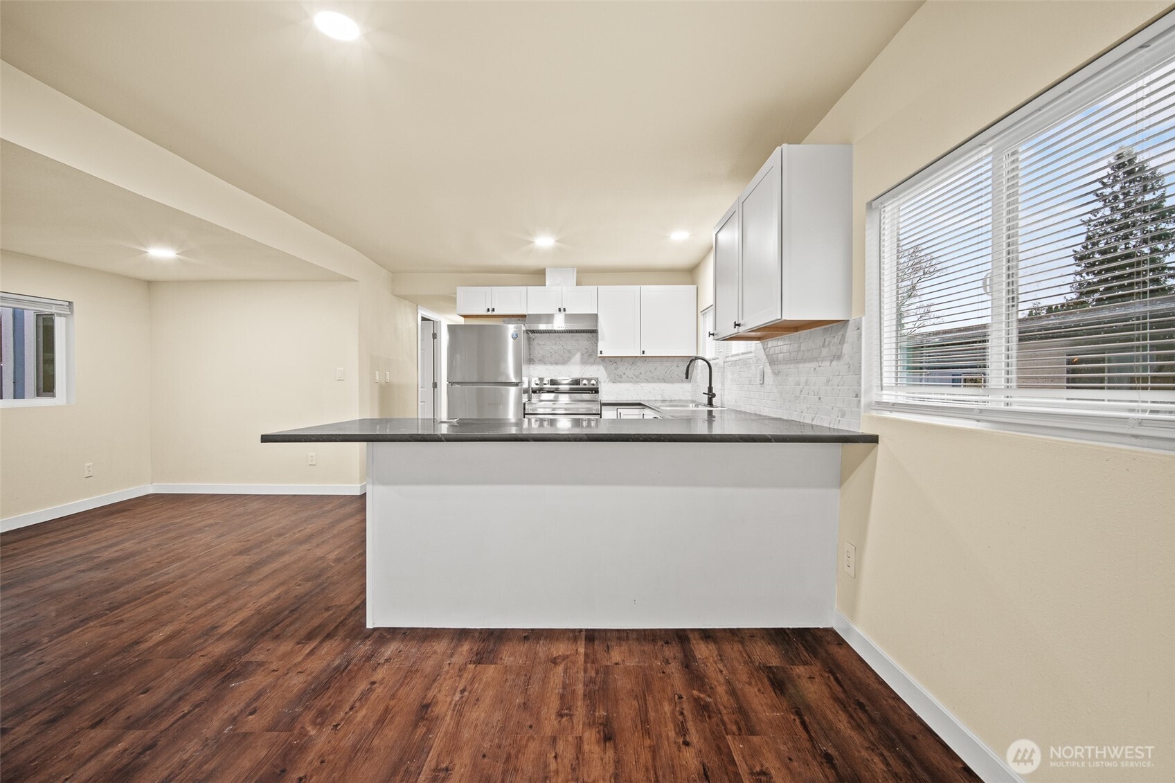 2392 Douglas Road, Unit 4 Ferndale, WA 98248 - Photo 6 of 39 a room with wooden floors and view kitchen