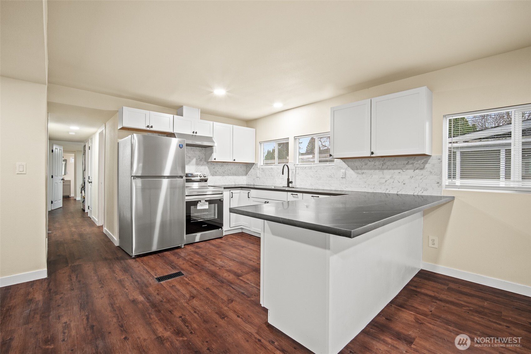 2392 Douglas Road, Unit 4 Ferndale, WA 98248 - Photo 7 of 39 a kitchen with granite countertop a refrigerator and a stove top oven