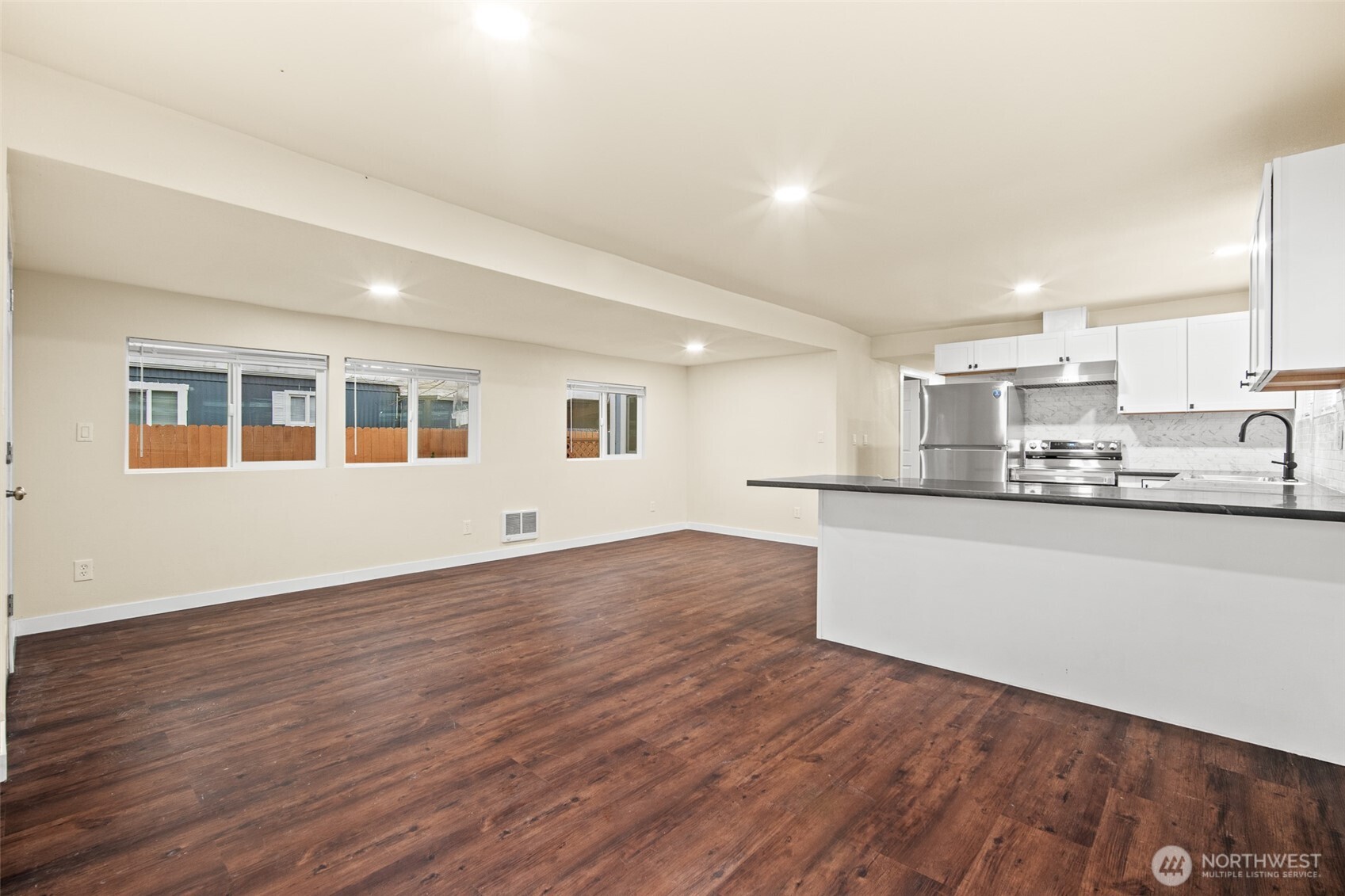 2392 Douglas Road, Unit 4 Ferndale, WA 98248 - Photo 9 of 39 a view of a kitchen with wooden floor and electronic appliances