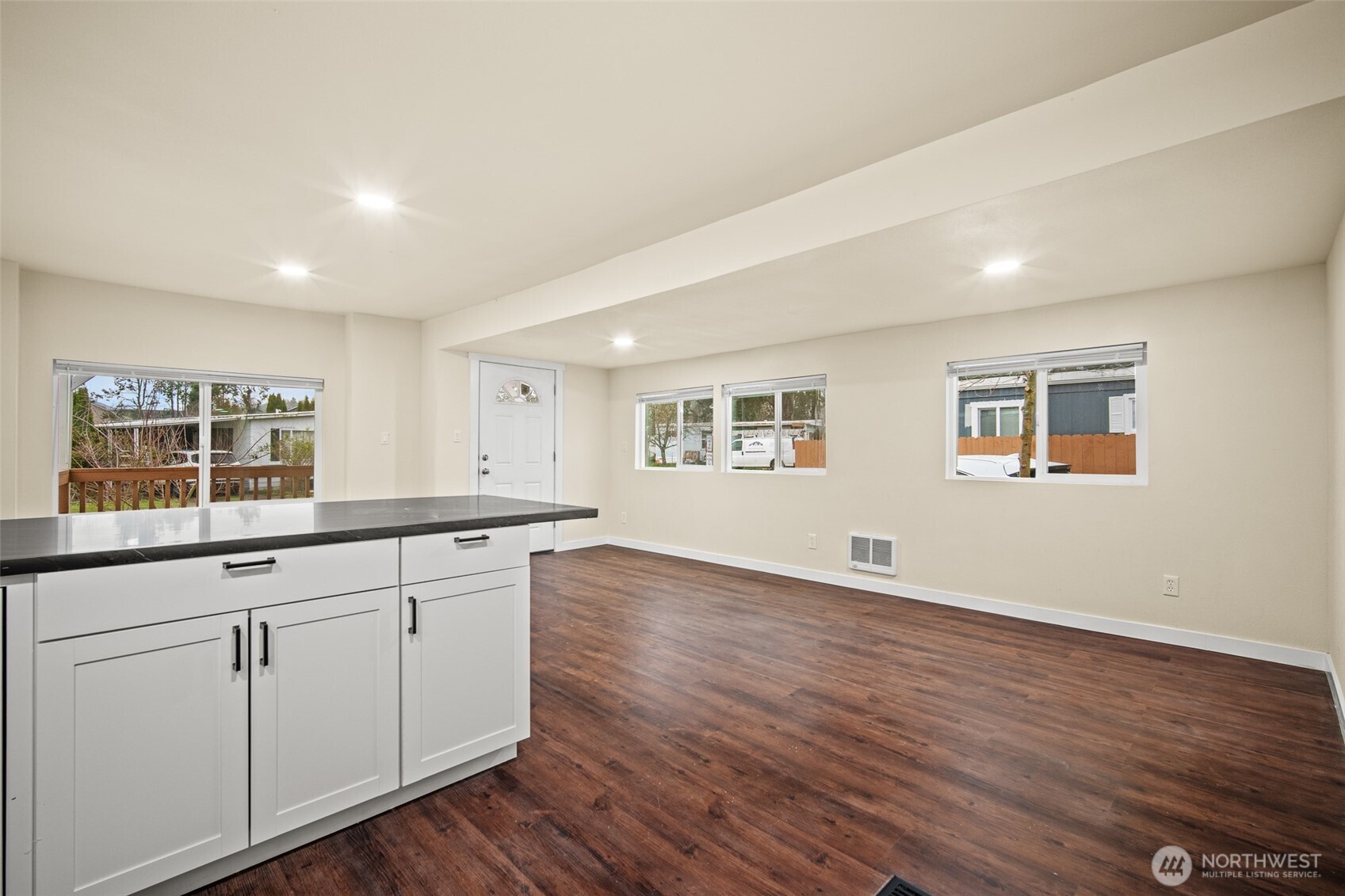 2392 Douglas Road, Unit 4 Ferndale, WA 98248 - Photo 10 of 39 a large white kitchen with wooden floor and cabinets