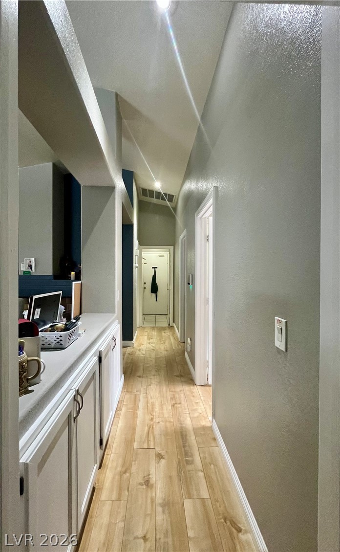 15 Rue Des Champs Henderson, NV 89074 - Photo 11 of 23 Gleaming hardwood floors guide you through a hallway detailed with high ceilings and built-in cabinetry.