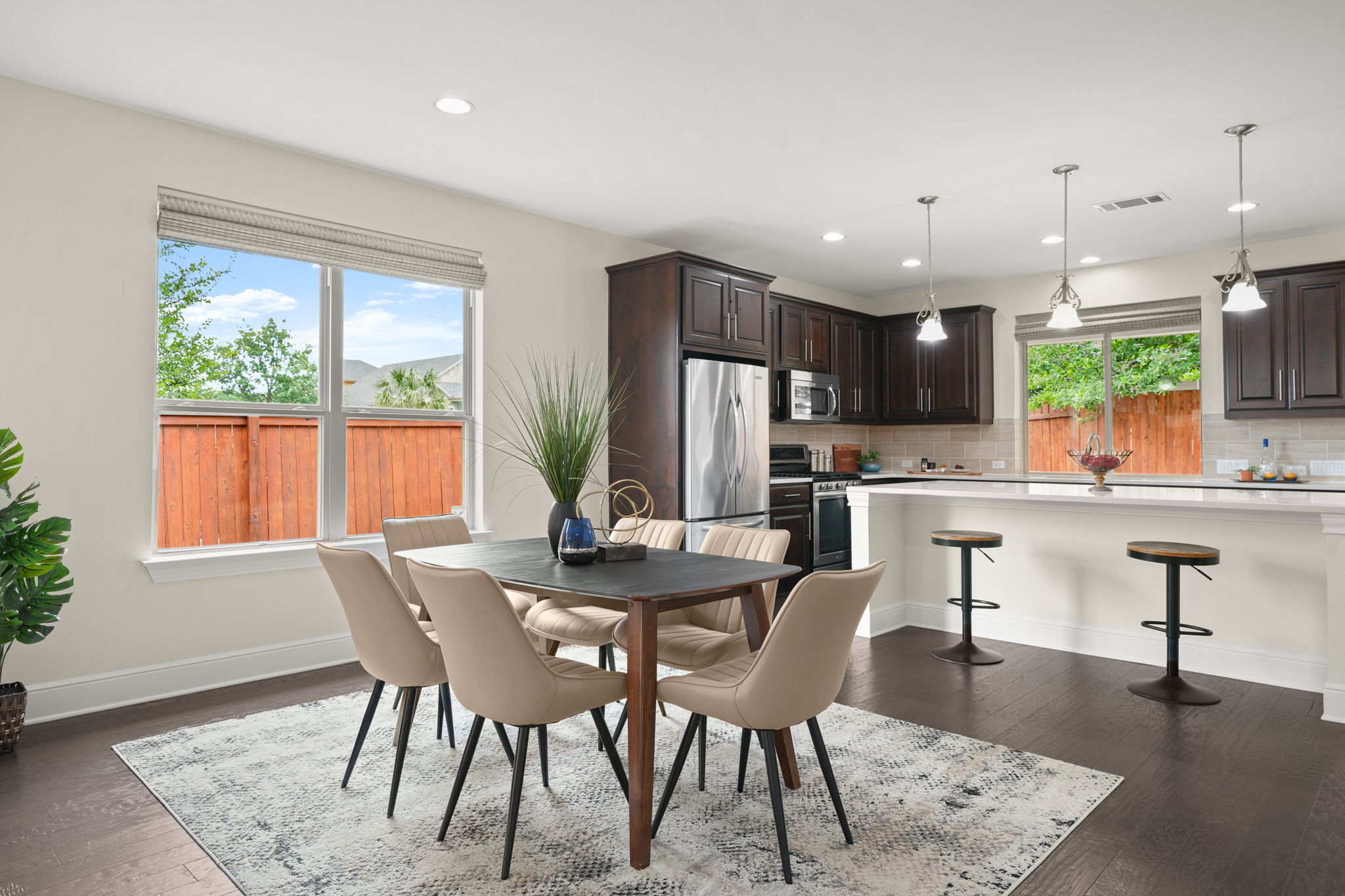 440 Cherokee Rose Circle Georgetown, TX 78626 - Photo 19 of 39 An open concept design seamlessly connects the dining area to the kitchen, offering both functionality and a welcoming atmosphere.