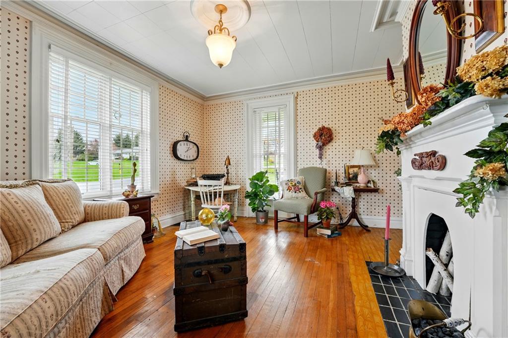 397 Evans City Road Butler, PA 16001 - Photo 21 of 50 a living room with furniture a fireplace windows and a chandelier
