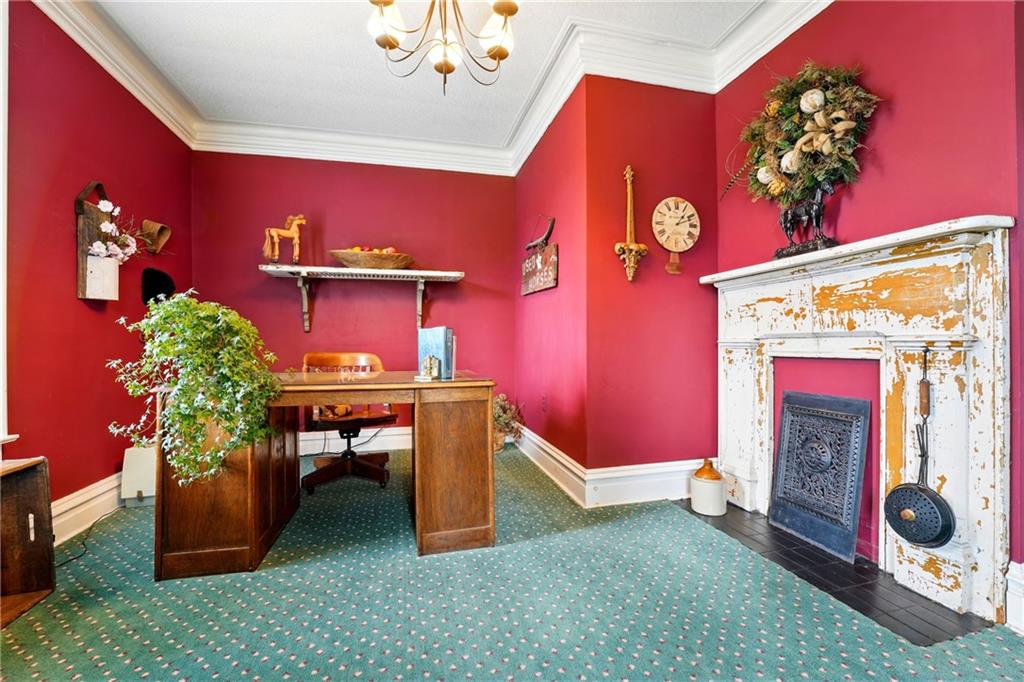 397 Evans City Road Butler, PA 16001 - Photo 23 of 50 a room with furniture a chandelier and a fireplace