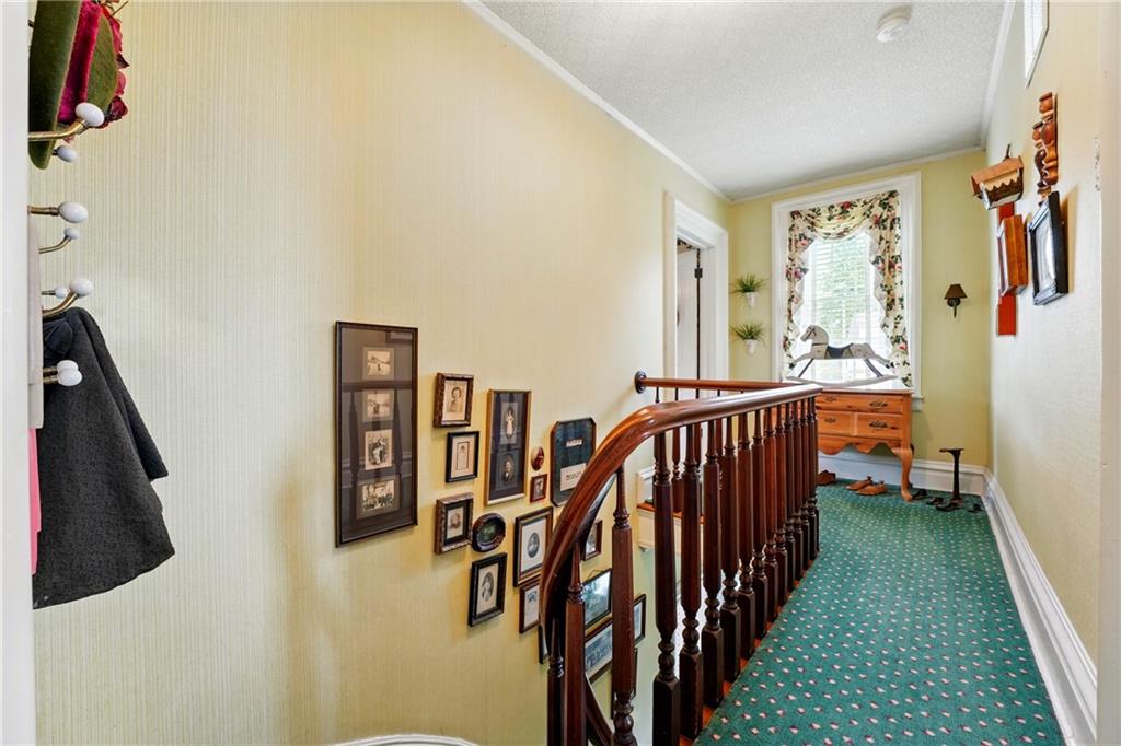 397 Evans City Road Butler, PA 16001 - Photo 24 of 50 a view of a hallway with lots of frames on wall
