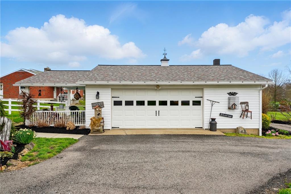 397 Evans City Road Butler, PA 16001 - Photo 33 of 50 a front view of a house with a garden and plants