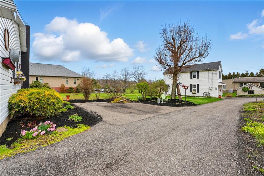 397 Evans City Road Butler, PA 16001 - Photo 37 of 50 a view of a garden with a building in the background