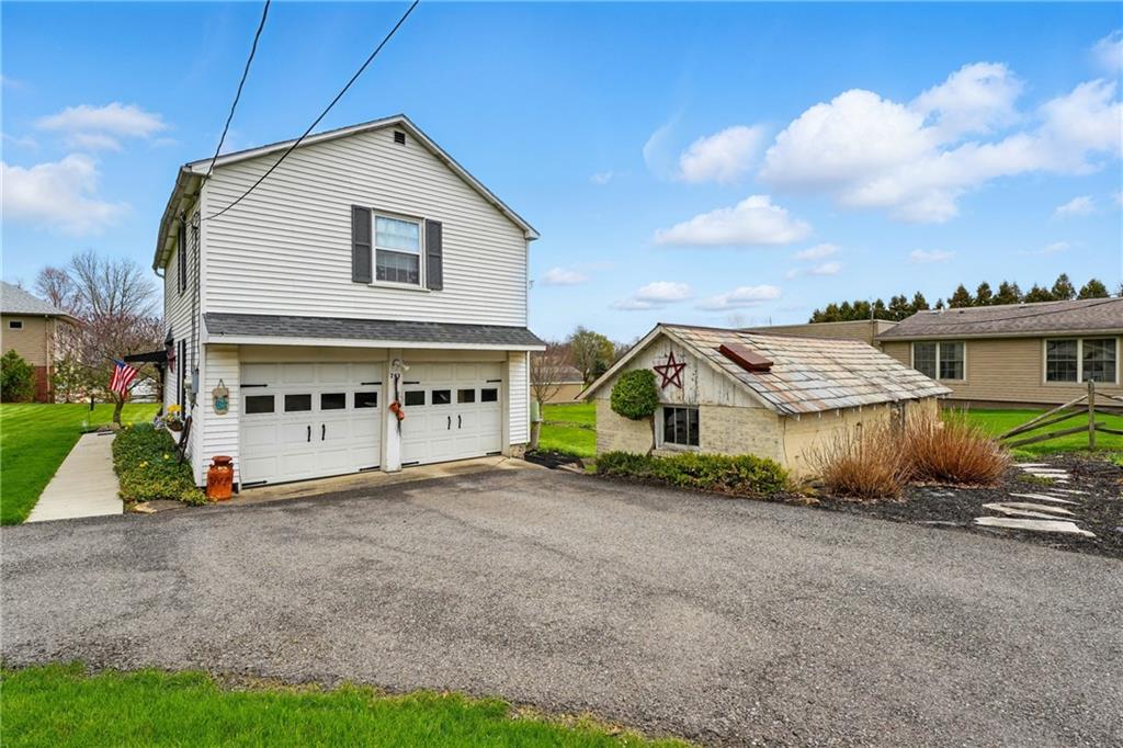 397 Evans City Road Butler, PA 16001 - Photo 38 of 50 a view of a house with a yard and potted plants