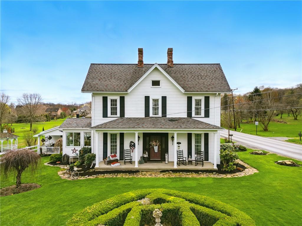 397 Evans City Road Butler, PA 16001 - Photo 6 of 50 a front view of a house with a yard table and chairs