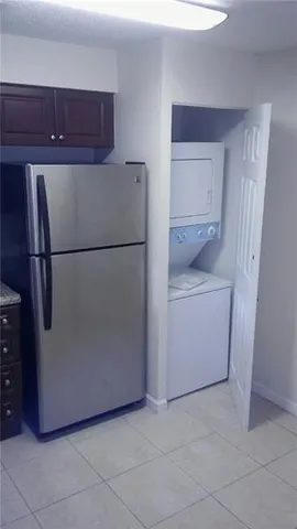 a white refrigerator freezer and a dishwasher sitting in a kitchen