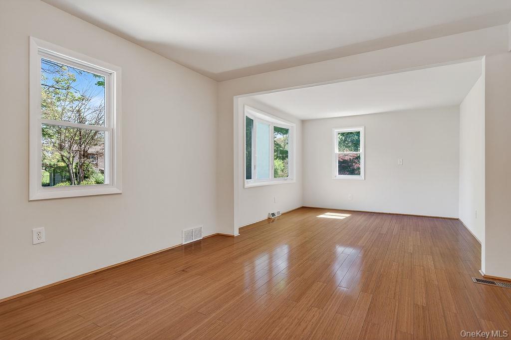 6 Winterberry Road Fishkill, NY 12524 - Photo 11 of 43 Bright interior with wood-finish flooring, freshly painted walls, multiple windows, a prominent bay window, and a recessed archway