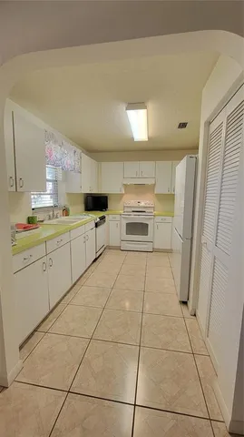a kitchen with stainless steel appliances a stove a sink and a refrigerator