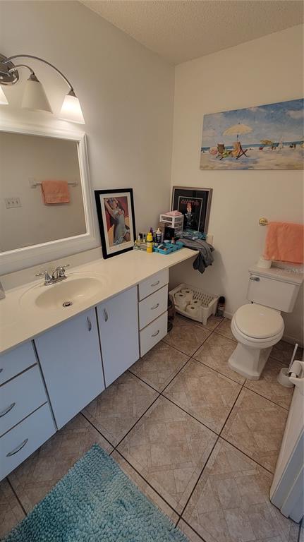 9331 Southwest 84th Terrace, Unit D Ocala, FL 34481 - Photo 19 of 32 a bathroom with a toilet sink and mirror