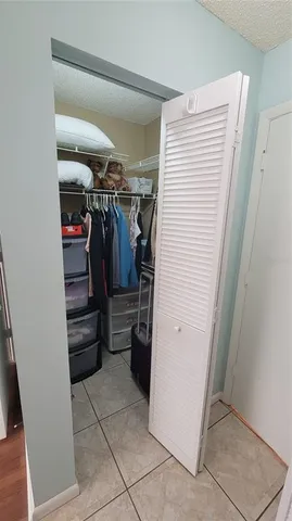 a view of walk in closet with clothes