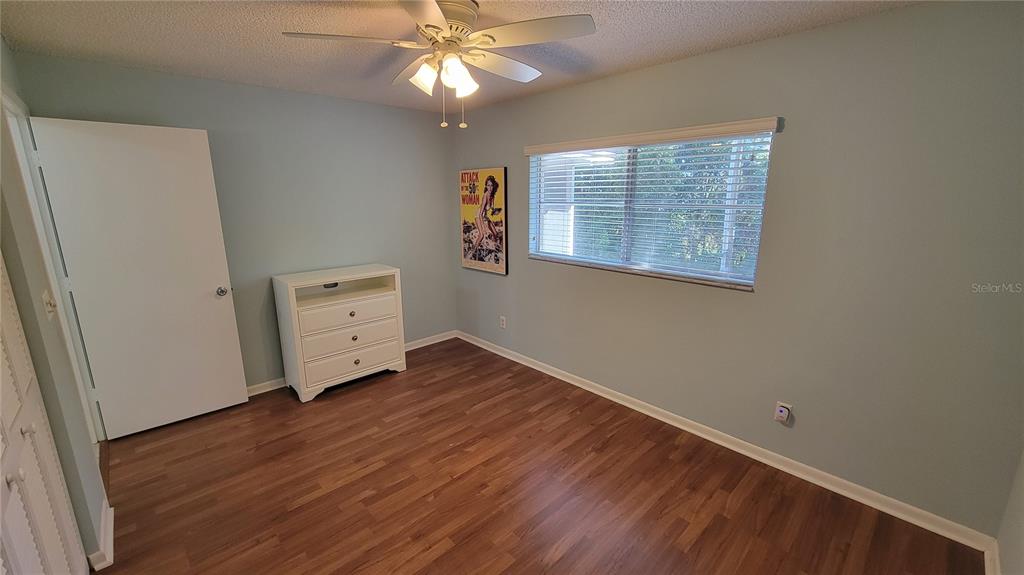 9331 Southwest 84th Terrace, Unit D Ocala, FL 34481 - Photo 23 of 32 wooden floor in an empty room with a window