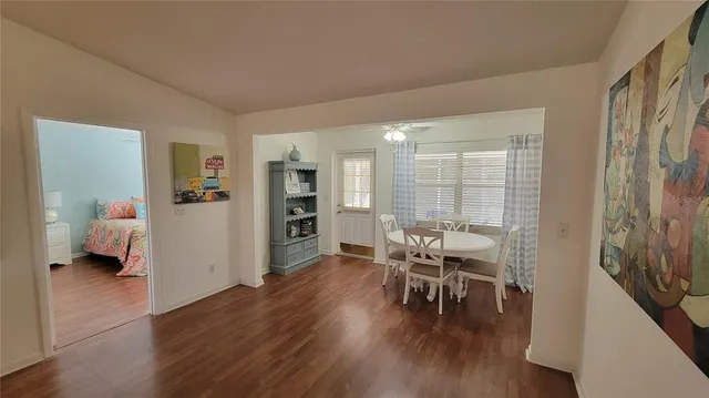 a dining room with furniture and wooden floor
