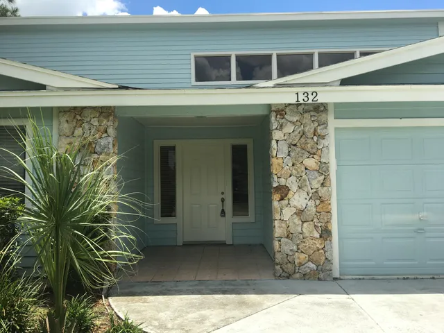 a view of a house with a window and front door