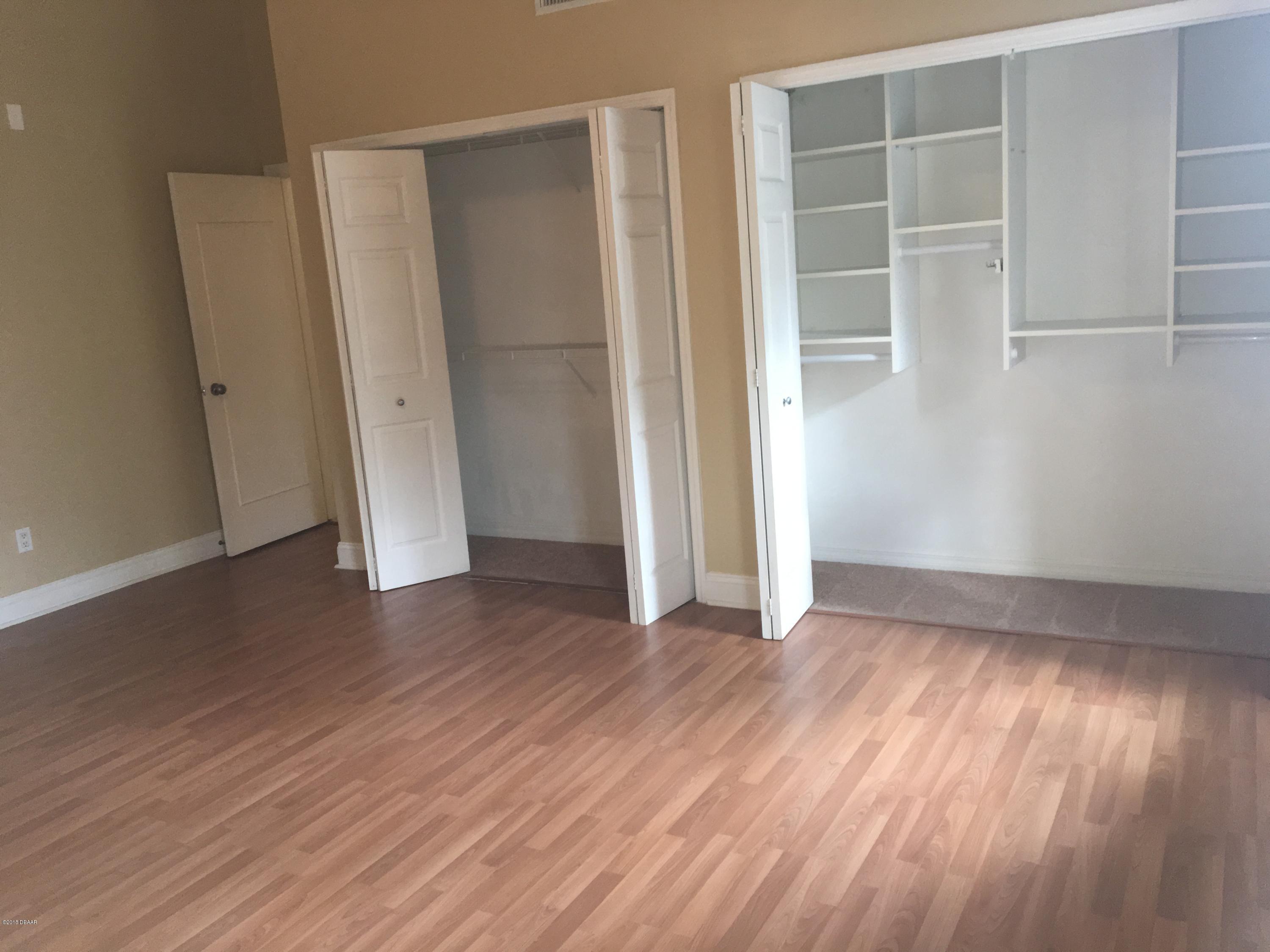 132 Tern Court Daytona Beach, FL 32119 - Photo 21 of 34 an empty room with wooden floor and windows