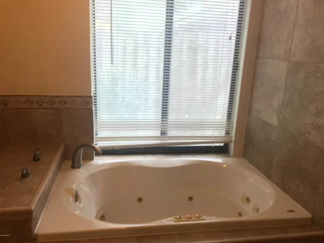 a bathroom with a bathtub and shower