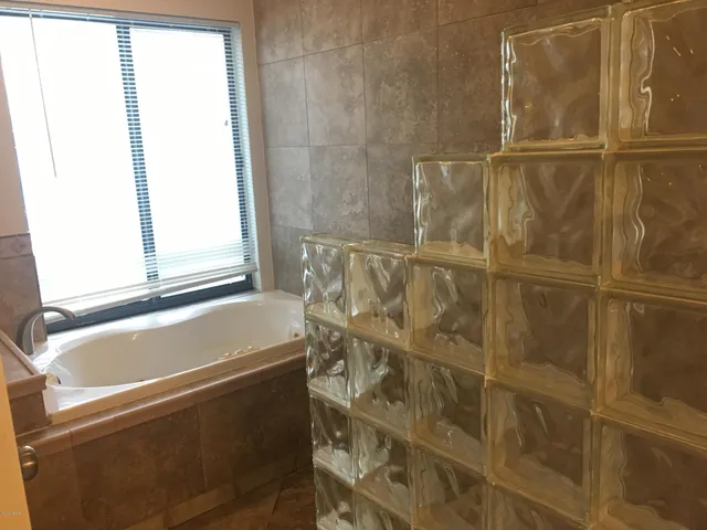 a bathroom with a sink a mirror and shower