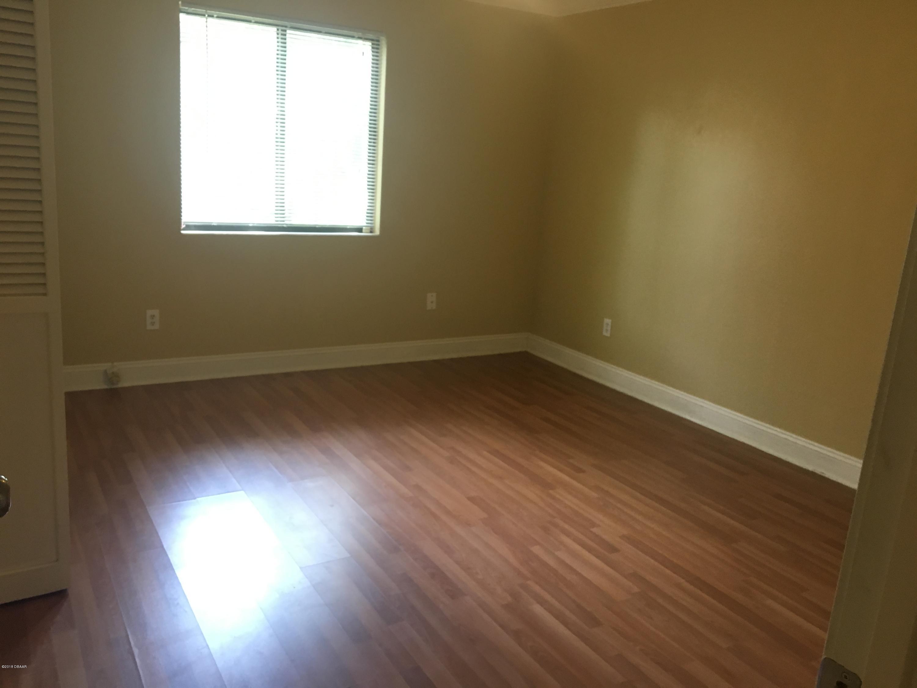 132 Tern Court Daytona Beach, FL 32119 - Photo 27 of 34 an empty room with wooden floor and windows