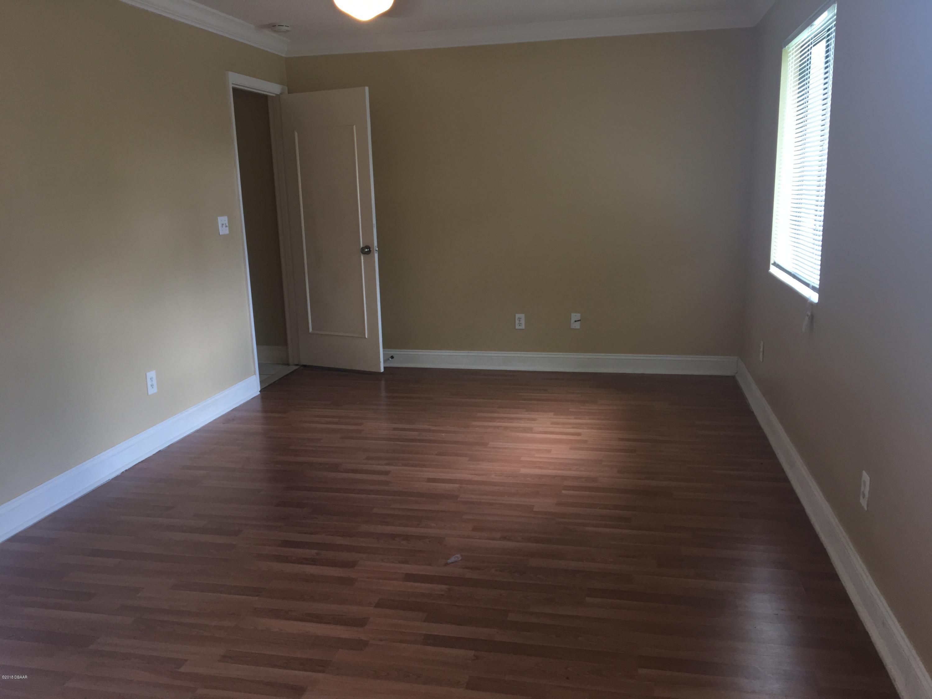132 Tern Court Daytona Beach, FL 32119 - Photo 31 of 34 a view of an empty room with wooden floor and a window
