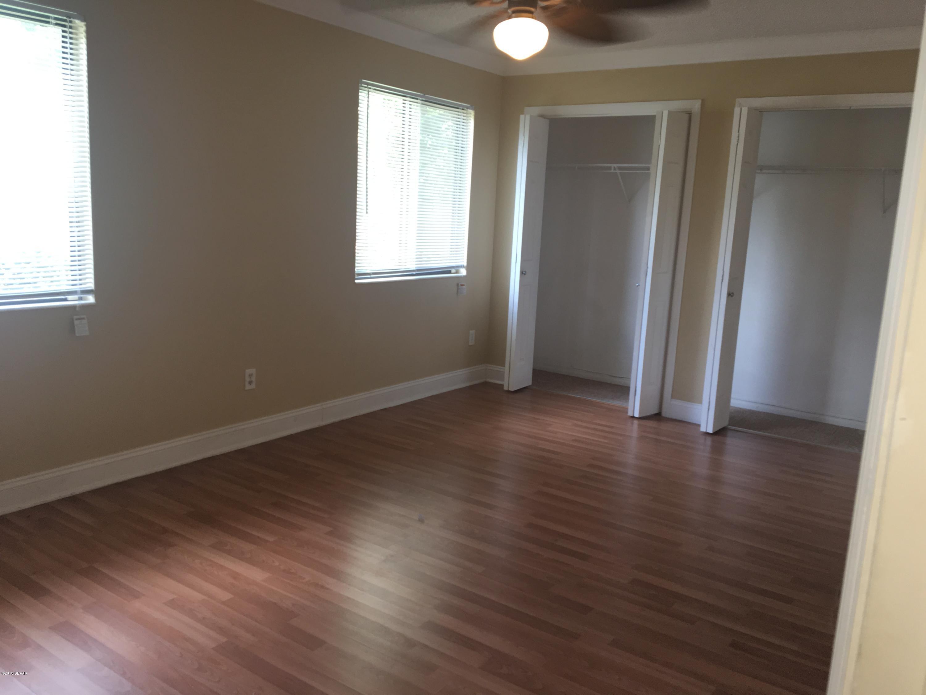 132 Tern Court Daytona Beach, FL 32119 - Photo 32 of 34 an empty room with wooden floor and windows