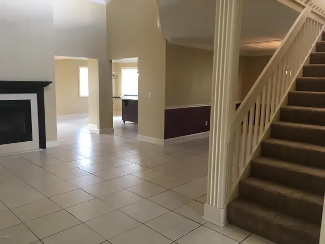 a view of an entryway with wooden floor and a fire place