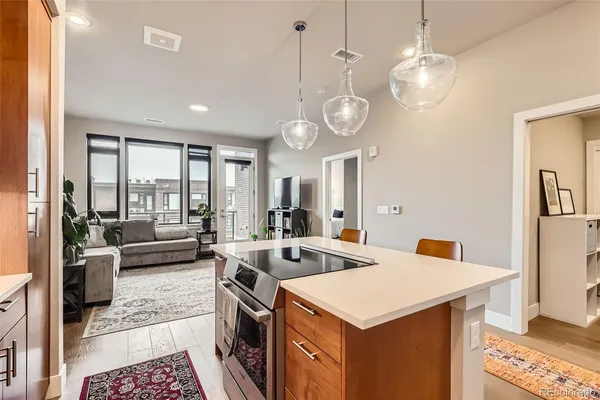 a kitchen with a table chairs and white cabinets