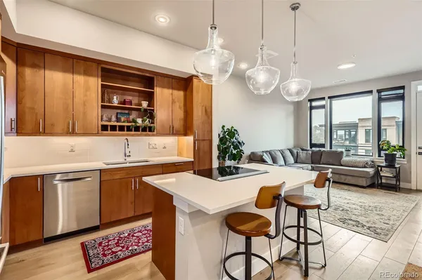 a living room with furniture and kitchen view