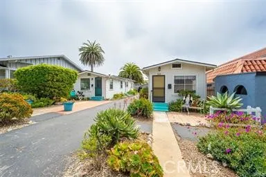 260 Pacific Street Morro Bay, CA 93442 - Photo 2 of 21 a front view of a house with a yard and potted plants