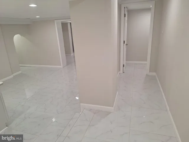 a white toilet sitting next to a bath tub