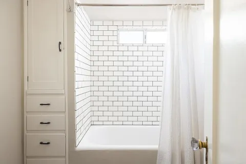 a bed room with a bed and a window