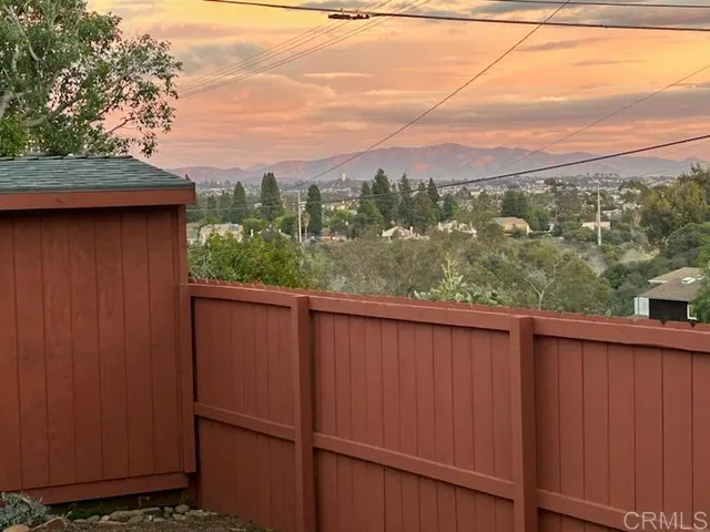 a view of a park with iron fence