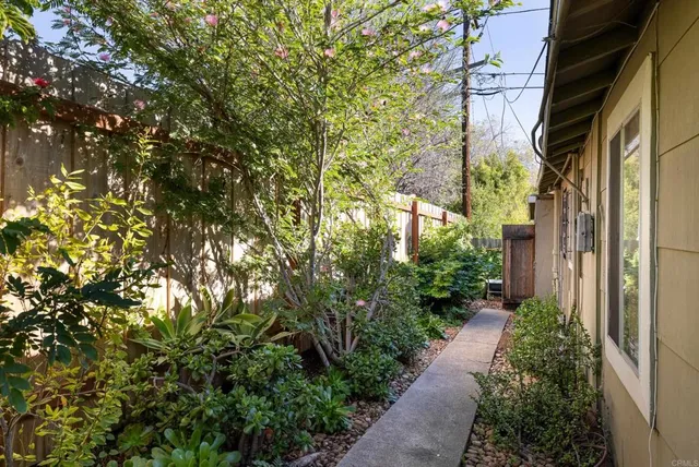 an aerial view of a house with a yard and outdoor seating
