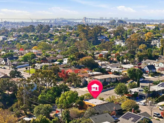 an aerial view of residential houses with outdoor space