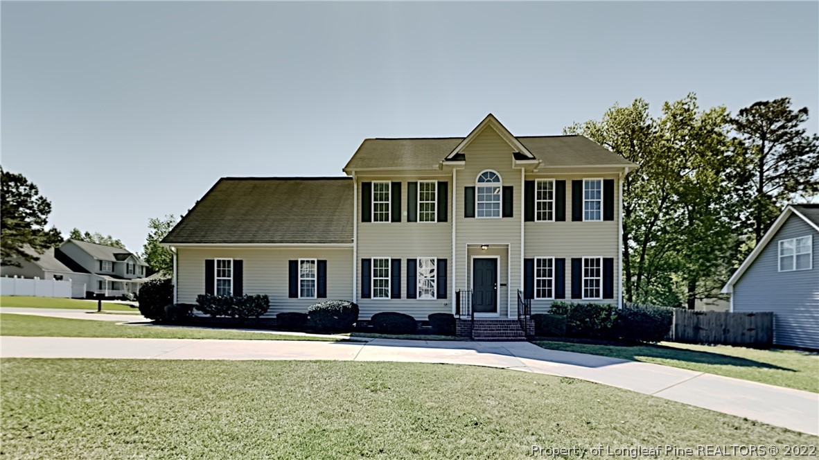 a front view of a house with a yard