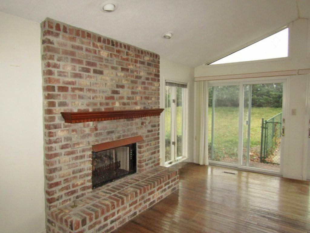 3143 Robinson Run Road McDonald, PA 15057 - Photo 13 of 37 a living room with a fireplace and wooden floor