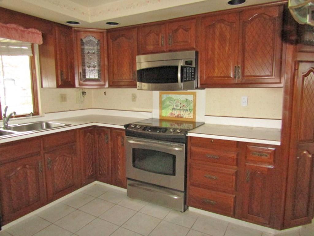 3143 Robinson Run Road McDonald, PA 15057 - Photo 17 of 37 a kitchen with granite countertop wooden cabinets stainless steel appliances and a sink
