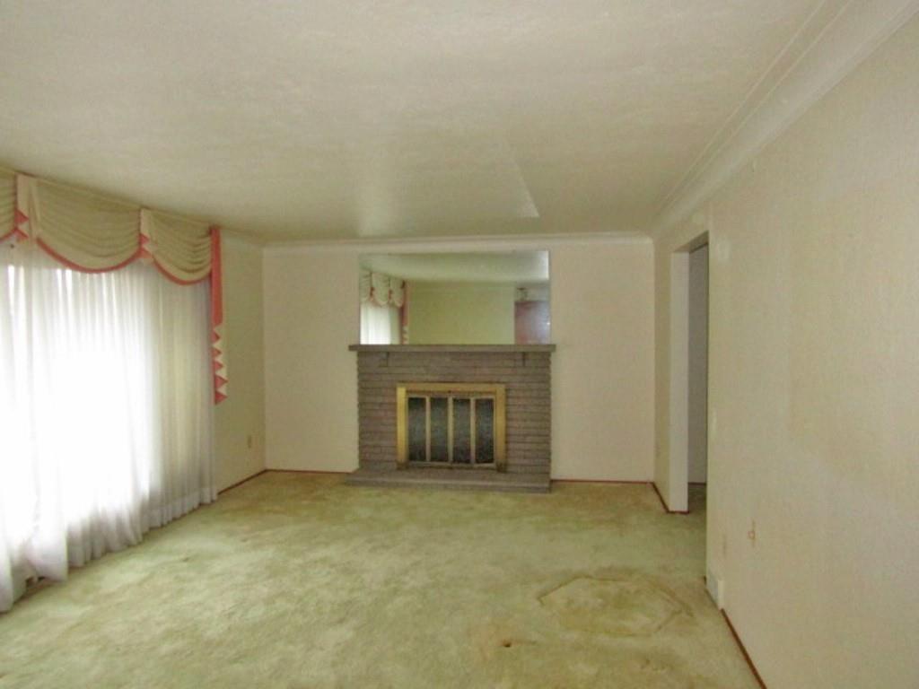 3143 Robinson Run Road McDonald, PA 15057 - Photo 7 of 37 a view of an empty room with a fireplace and a window
