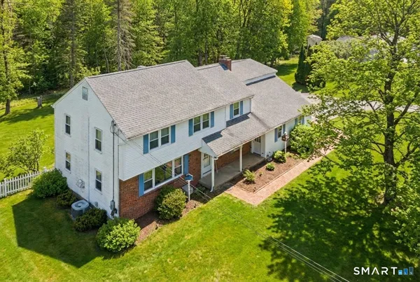 an aerial view of a house with a yard table and chairs