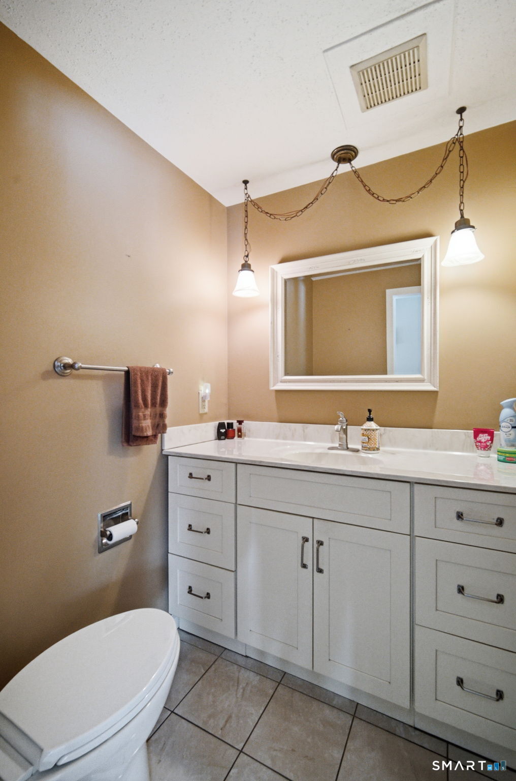 45 Sokol Road Somers, CT 06071 - Photo 12 of 36 a bathroom with a toilet a sink a mirror and vanity