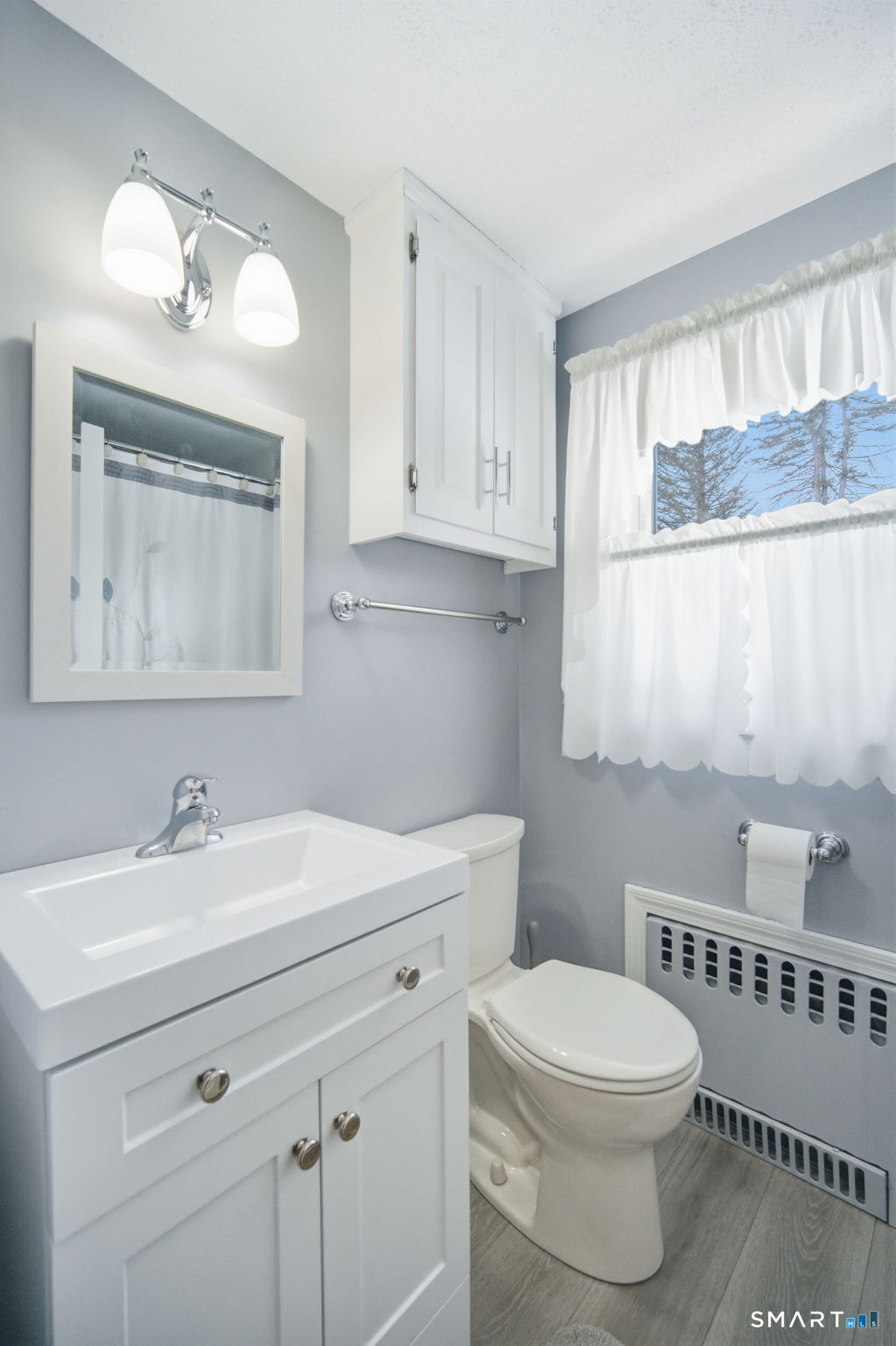 45 Sokol Road Somers, CT 06071 - Photo 28 of 36 a bathroom with a toilet a sink a mirror and a window