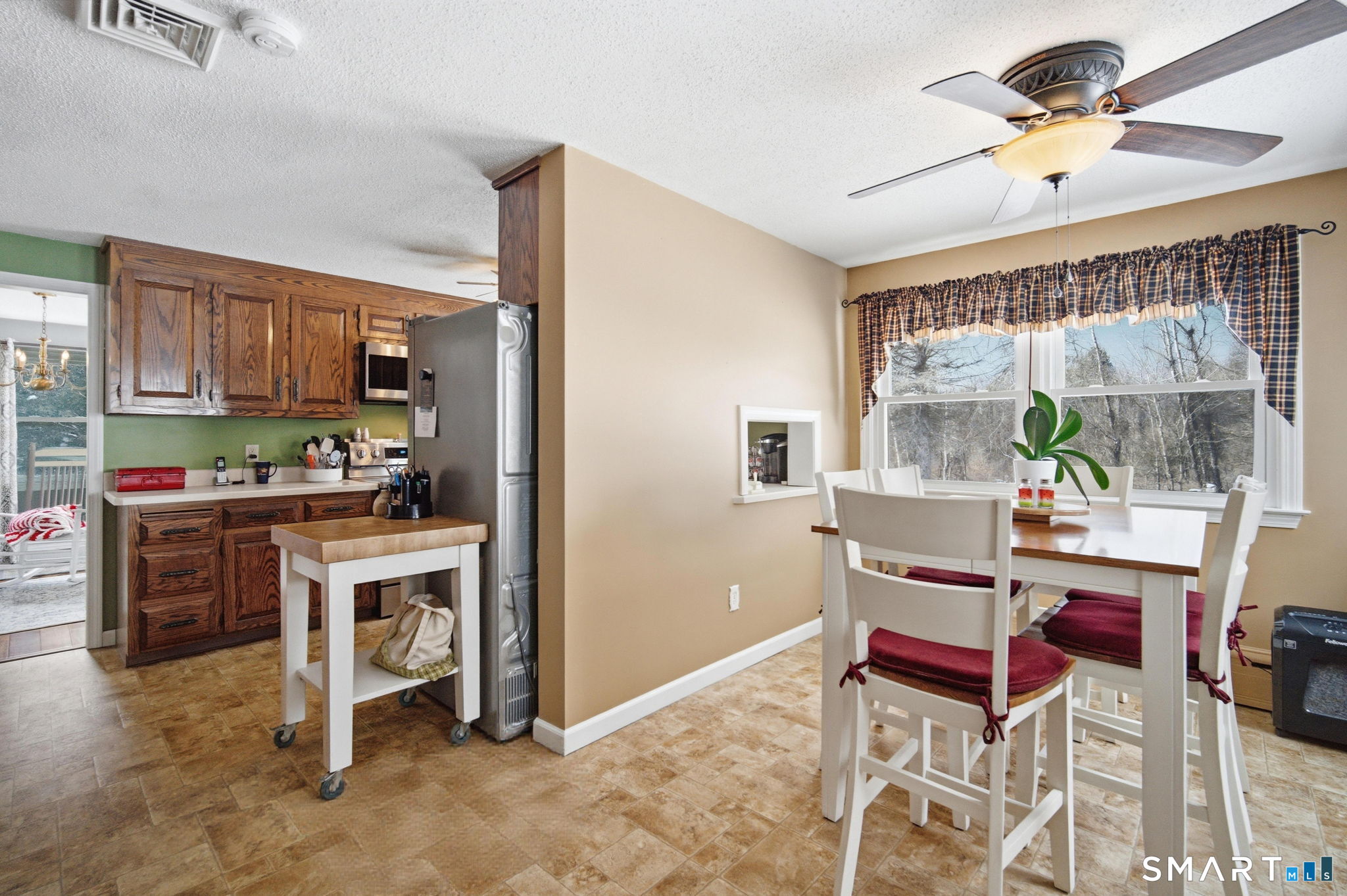 45 Sokol Road Somers, CT 06071 - Photo 7 of 36 a kitchen with a dining table chairs and a refrigerator