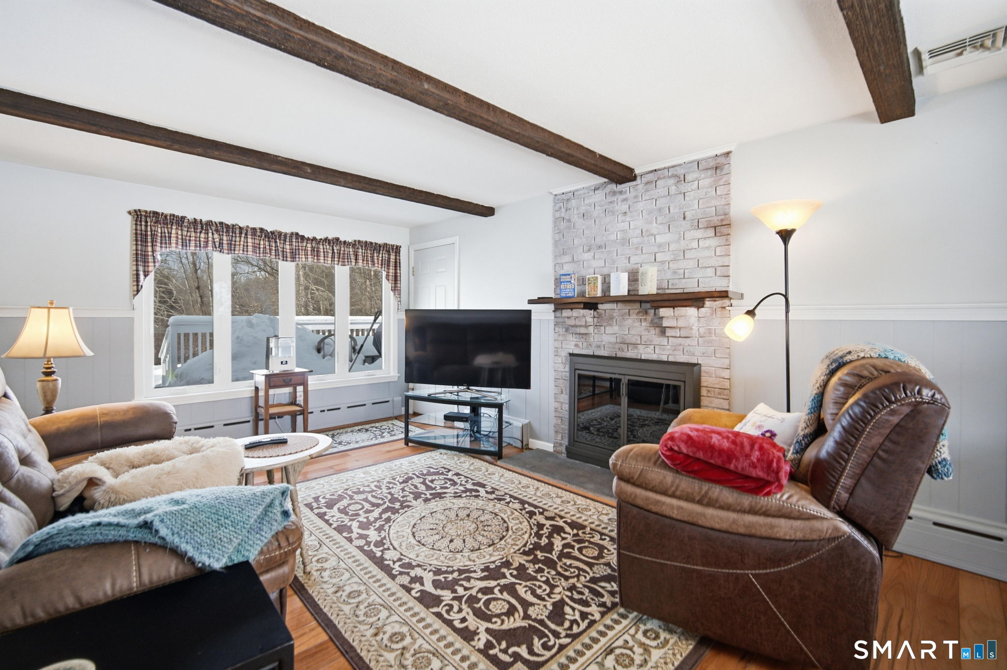 45 Sokol Road Somers, CT 06071 - Photo 9 of 36 a living room with furniture a flat screen tv and a fireplace