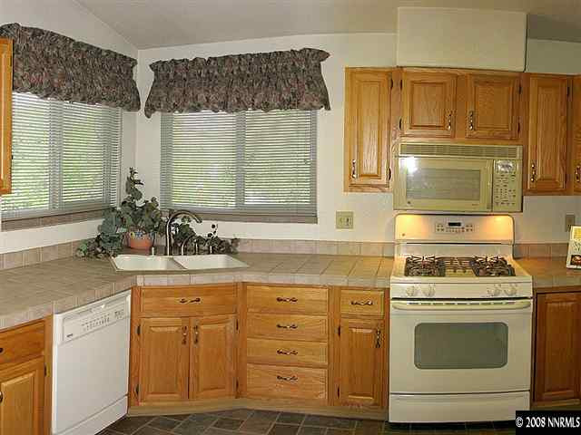 22886 Blackwillow Way Reno, NV 89521 - Photo 5 of 9 a kitchen with cabinets appliances a sink and a window