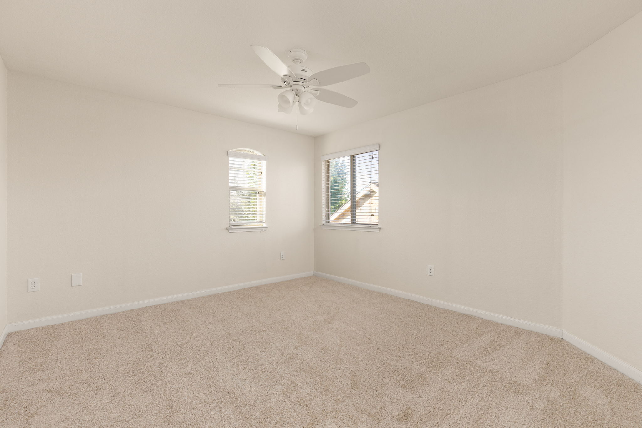 2400 Leonards Pass Leander, TX 78641 - Photo 32 of 40 A quiet bedroom offers comfort with soft carpet and a ceiling fan for climate control.