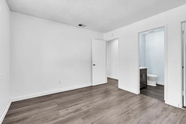 a view of a room with wooden floor and a window