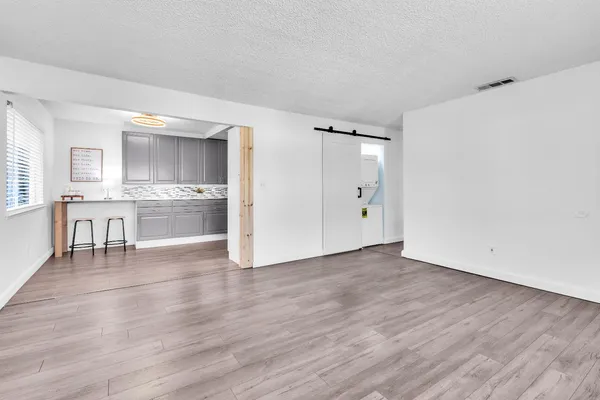 a kitchen with stainless steel appliances granite countertop a refrigerator and a stove top oven