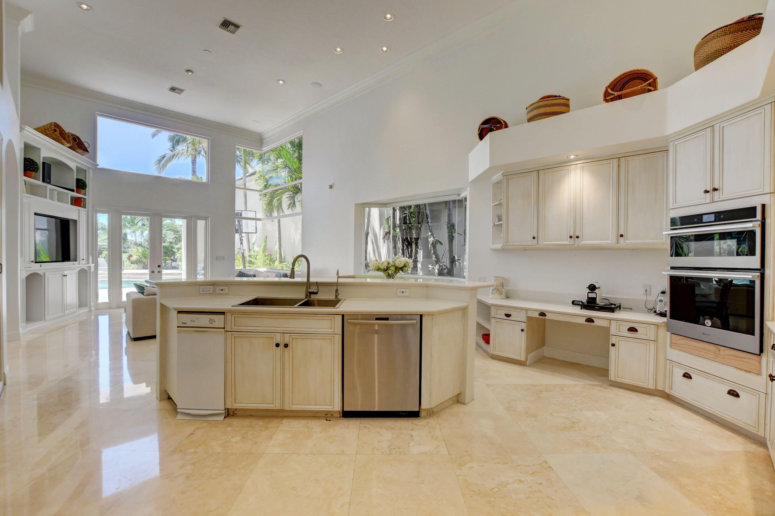 6174 Northwest 24th Way Boca Raton, FL 33496 - Photo 20 of 58 a large white kitchen with stainless steel appliances granite countertop a stove and a sink